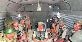 Central Reserve Police Force personnel rest in a vehicle in Srinagar on Monday.