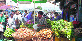 People buy vegitables at a market after a three-day shutdown, in Srinagar on Monday.