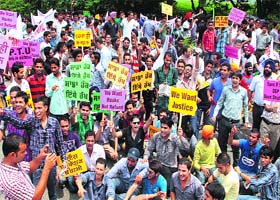 Members of the PTU Distance Education Programme Learning Centres Association, block the Jalandhar-Kapurthala highway on Monday