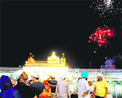 Spectacular view of fireworks to mark the birth anniversary of Shri Guru Harkrishan Sahib at the Golden Temple in Amritsar on Tuesday. Photo: Vishal Kumar