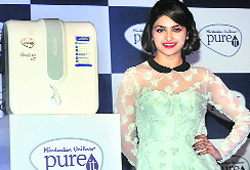 Bollywood actress Prachi Desai poses with 'Pureit Marvella RO Slim' water filter at its launch in New Delhi on Tuesday. It is priced at Rs 10,990 and is available across the country. Tribune photo: Manas Ranjan Bhui