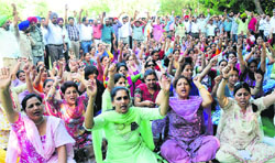 Members of the Joint Action Committee of UT Schoolteachers hold a protest at Sector 17 in Chandigarh on Tuesday.
