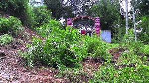 A landslide blocks the gate of Baba Balak Nath Temple in Kangra on Tuesday following heavy rain.