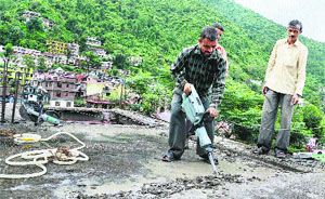 MC labourers demolish an illegal structure at Mandi on Monday. 