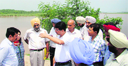 Deputy Commissioner Rahul Tiwari gives instructions to officials of the district administration during a visit to flood-prone areas in Ludhiana on Tuesday. A Tribune Photograph