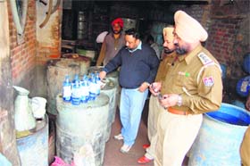 Police officials taking samples of the seized turpentine oil from a factory in Amritsar