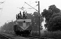 Railway engineers lay new high-tension wires on the Ambala-Delhi railway line near the Rajlu Garhi railway station on Wednesday