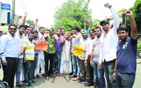 Members of the Ludhiana Youth Congress hold a protest outside the Government College for Boys in Ludhiana on Wednesday