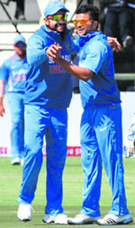 Virat and Raina celebrate the dismissal of a Zimbabwe batsman.