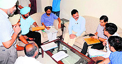 Officials of the district and police administration appear before the National SC Commission vice-chairman Dr Rajkumar Verka (centre) in Amritsar on Thursday