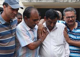 Samvit's father CN Raina (second from right) breaks down after identifying the body on Thursday