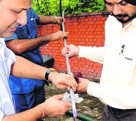 Officials test the quality of diesel at the CTU workshop