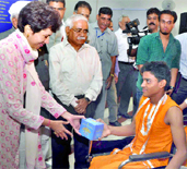 Union Minister of Social Justice and Empowerment Kumari Selja presents a memento to a child during the first edition of the fair Swavalamban at Pragati Maidan in New Delhi on Thursday.