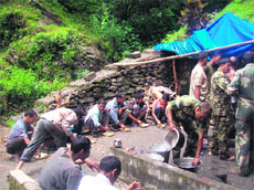BSF jawans run a community kitchen for victims of the natural disaster in the Kalimath area of Garhwal on Thursday.