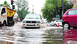 Vehicles wade through a waterlogged street in Gurgaon