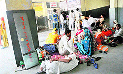 Visitors and attendants of the patients sitting on the floor outside the maternity ward in the Kalpana Chawla Medical College, Karnal