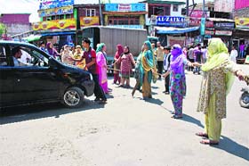 Chain Reaction: Women make a human chain to stop vehicles during a protest against water scarcity in Nowpora area of Srinagar on Thursday