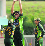 Mohammad Irfan (C) waits for a high five from Ahmed Shehzad (L) after Marlon Samuels is caught by Umar Akmal. Captain Misbah-Ul-Haq looks on.  AFP