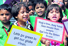 A visually impaired student waters a sapling during a plantation drive at the Institute for Blinds in Sector 26, Chandigarh; and (right) children from Small Wonders School spread awareness on environment conservation at Phase VII in Mohali on Friday