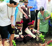 A visually impaired student waters a sapling during a plantation drive at the Institute for Blinds in Sector 26, Chandigarh; and (right) children from Small Wonders School spread awareness on environment conservation at Phase VII in Mohali on Friday
