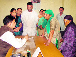 Minister for Housing and Urban Development Sudhir Sharma listens to public problems at Dharamsala on Friday.