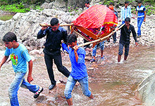 Villagers carry palki of a bride at Sunderbani area of Rajouri