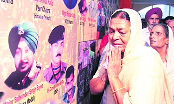 Families of martyrs of the Kargil war share their grief during a programme organised on Vijay Divas in Jalandhar on Friday.
