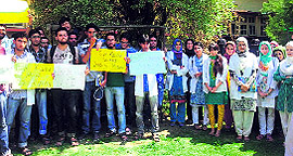Members of the Resident Doctors Association of Kashmir protest on the premises of Government Medical College in Srinagar on Friday