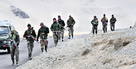 Indian soldiers patrol along the LAC.