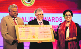 CBI Director Ranjit Sinha and Chief Justice of India Justice P Sathasivam present the Ramnath Goenka Award for excellence in journalism to Chitleen K Sethi in New Delhi for her investigative reports on seats-for-sale in PGI, Chandigarh. The reports were carried in The Tribune in 2010.