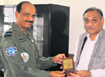 Air Commodore Rajesh Issar presents a memento to CM Vijay Bahuguna in Dehradun on Friday.