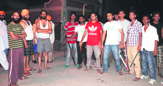 Youths of Indira Colony carry a night patrol in Amritsar on Saturday. Photo: Vishal Kumar