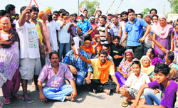 Residents of Chabbal Road protest against the dumping site in Amritsar on Saturday. A Tribune Photograph 