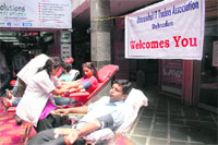 Volunteers donate blood at a camp organised by the Uttaranchal IT Traders Assocation at Capri Trade Centre, Dehradun, on Saturday.