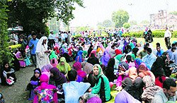 Entrance test aspirants wait at a park in Srinagar on Saturday