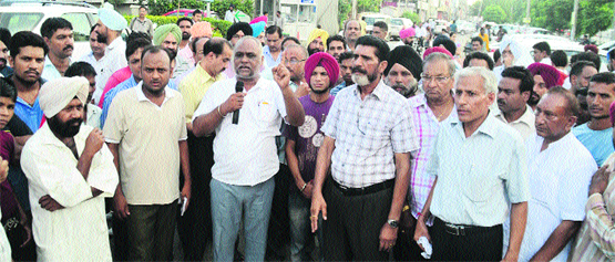 Shopkeepers protest in Ludhiana on Saturday. Photo: Inderjeet Verma