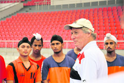 Indias former hockey coach Michael Nobbs with young trainees at the Hockey Stadium in Mohali. 