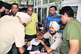 Policemen record the statement of the shop owner in Bathinda on Sunday