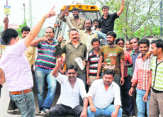 Local hoarding advertisers association members stop JCB machines from removing hoardings at various sites in Haridwar on Sunday.