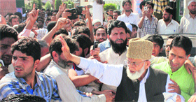 Hurriyat Conference leader Syed Ali Shah Geelani defies detention orders to address a gathering near his residence in Srinagar on Sunday.