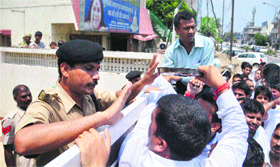 Bharatiya Janata Yuva Morcha workers argue with a policeman at the residence of Minister of Information and Broadcasting Manish Tewari in Ludhiana.