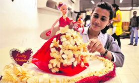 A girl participates in a doll designing competition during an inter-school talent hunt competition at the Sportking Institute of Fashion Technology in Ludhiana.