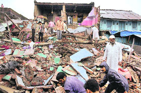People look for survivors among the debris in Kannod township of Dewas district in Madhya Pradesh on Sunday. 