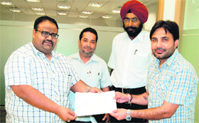 Members of the managing committee of Alpha One Mall give a cheque for Rs 55 lakh to Superintendent, House Tax Department, MC, Sushant Bhatia (extreme right) in Amritsar on Monday.