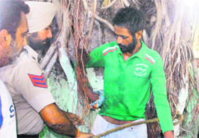 A youth, who was held captive by residents in the New Hamidpura colony taking him to be a member of a gang, being rescued by the police in Amritsar on Monday.