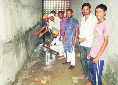 Water percolates from the tank of the waterworks at Mann village in Muktsar district.