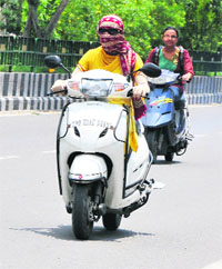 With mercury soaring, two-wheeler riders are making every effort to escape the heat in Bathinda