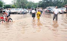 People wade through a waterlogged street in Dera Bassi on Monday