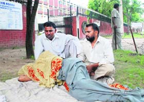 Seeking justice: A woman lies outside the Headquarters of the Haryana Police in Panchkula on Monday