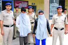 The accused in a murder case in police custody in Dehradun on Monday.